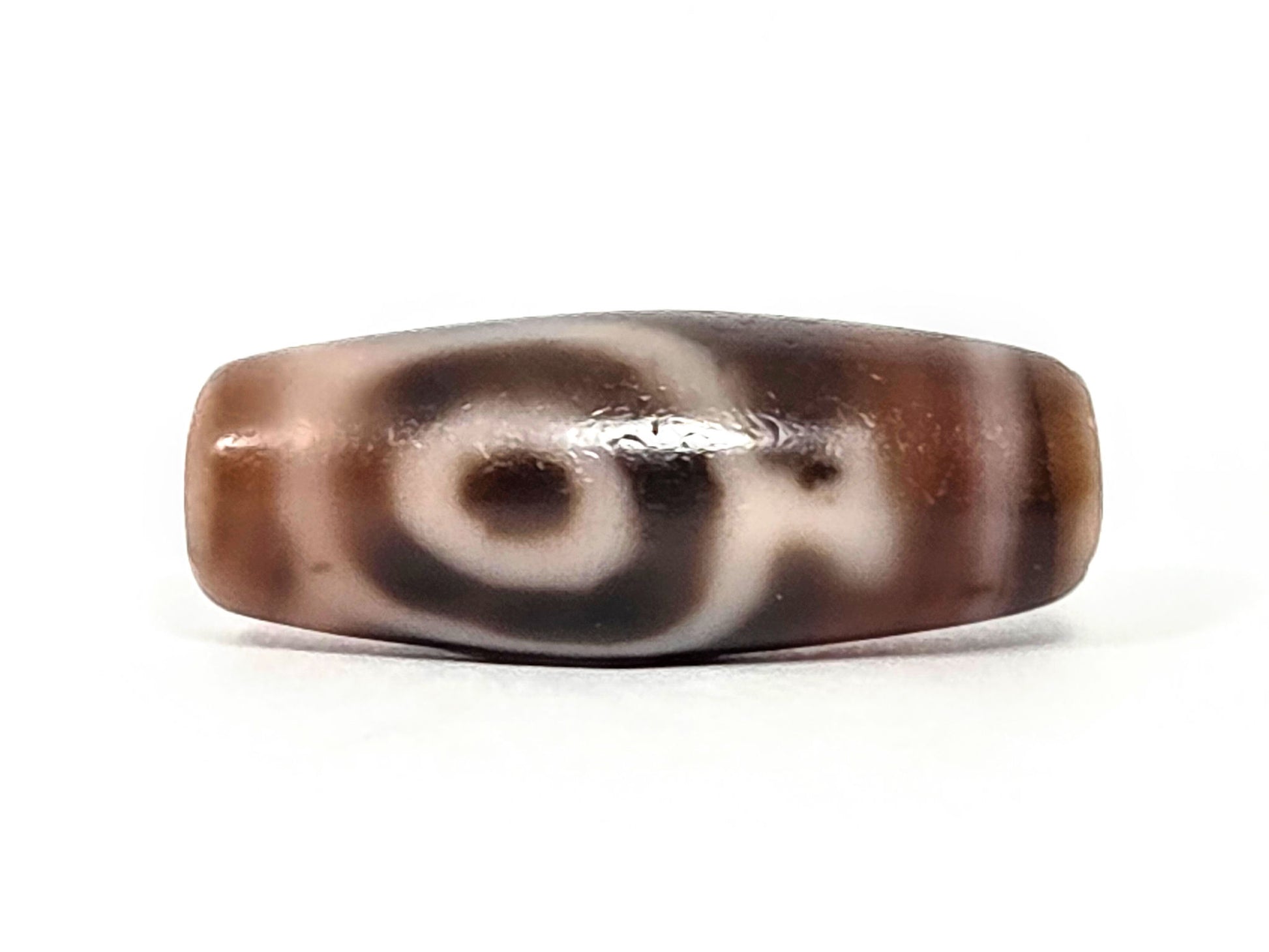 At-061826-2ETV Face B, closed oval eye ring on warm chocolate-brown chalcedony, soft-edged cream motif lines, unretouched