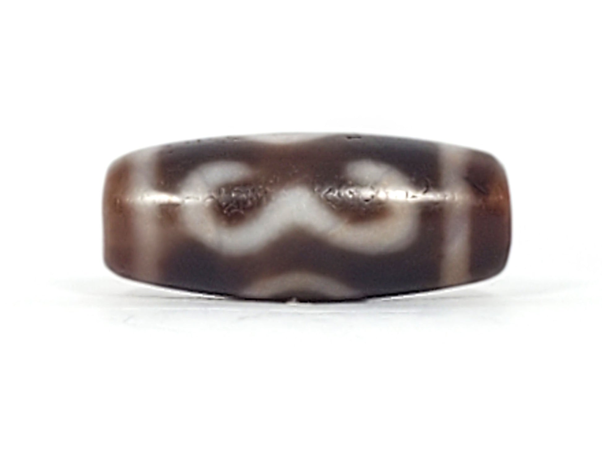 Third angle of antique Double Bat Two Eye dzi At-053026-DB2E, stylised bat wing silhouette with integrated two-eye motif, deep dark brown agate, 28.8mm × 12.0mm, unretouched