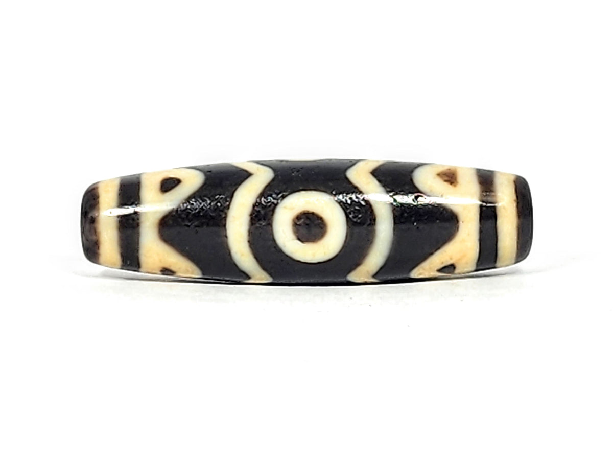 At-061926-3ETT Face C, third closed eye, open tiger tooth arcs, pitch-black ground, unretouched