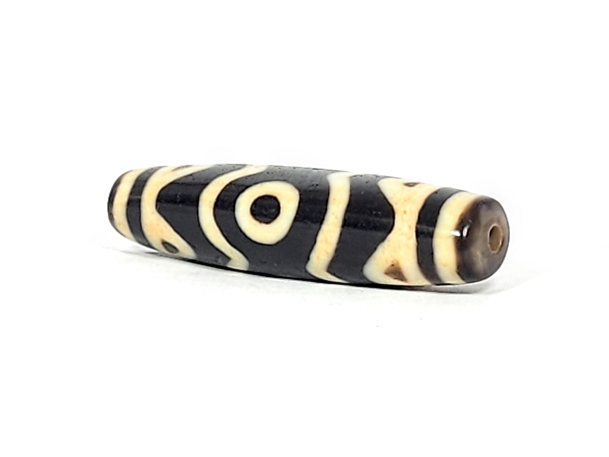 At-061926-3ETT angled tip A, warm dark brown end cap, clean drill hole, motif wrap visible, unretouched