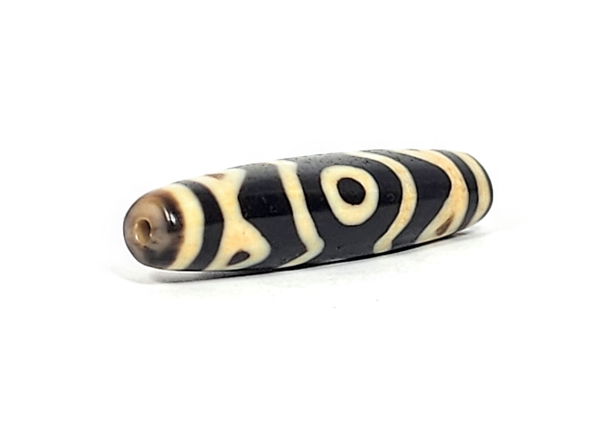 At-061926-3ETT angled tip B, elongated fusiform form, honey-brown end cap, drill hole, unretouched