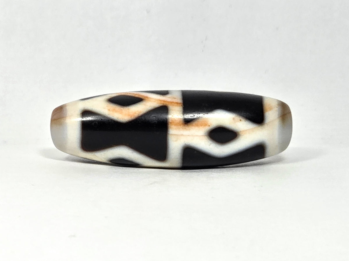 At-062126-6DE dzi bead, three-quarter angle, step-line divider detail, unretouched
