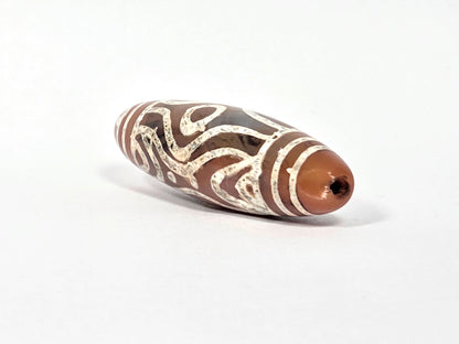 At-061426-2ETTSt carnelian dzi, intact left end cap, terracotta-red tip, clean drill hole, hairline disclosed, unretouched