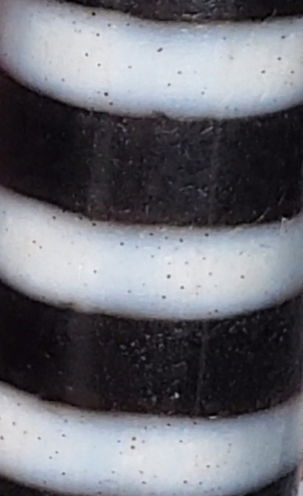 At-110223-9SBS, macro showing cinnabar micro-dots in stripe bands and surface score line on dark bands, unretouched