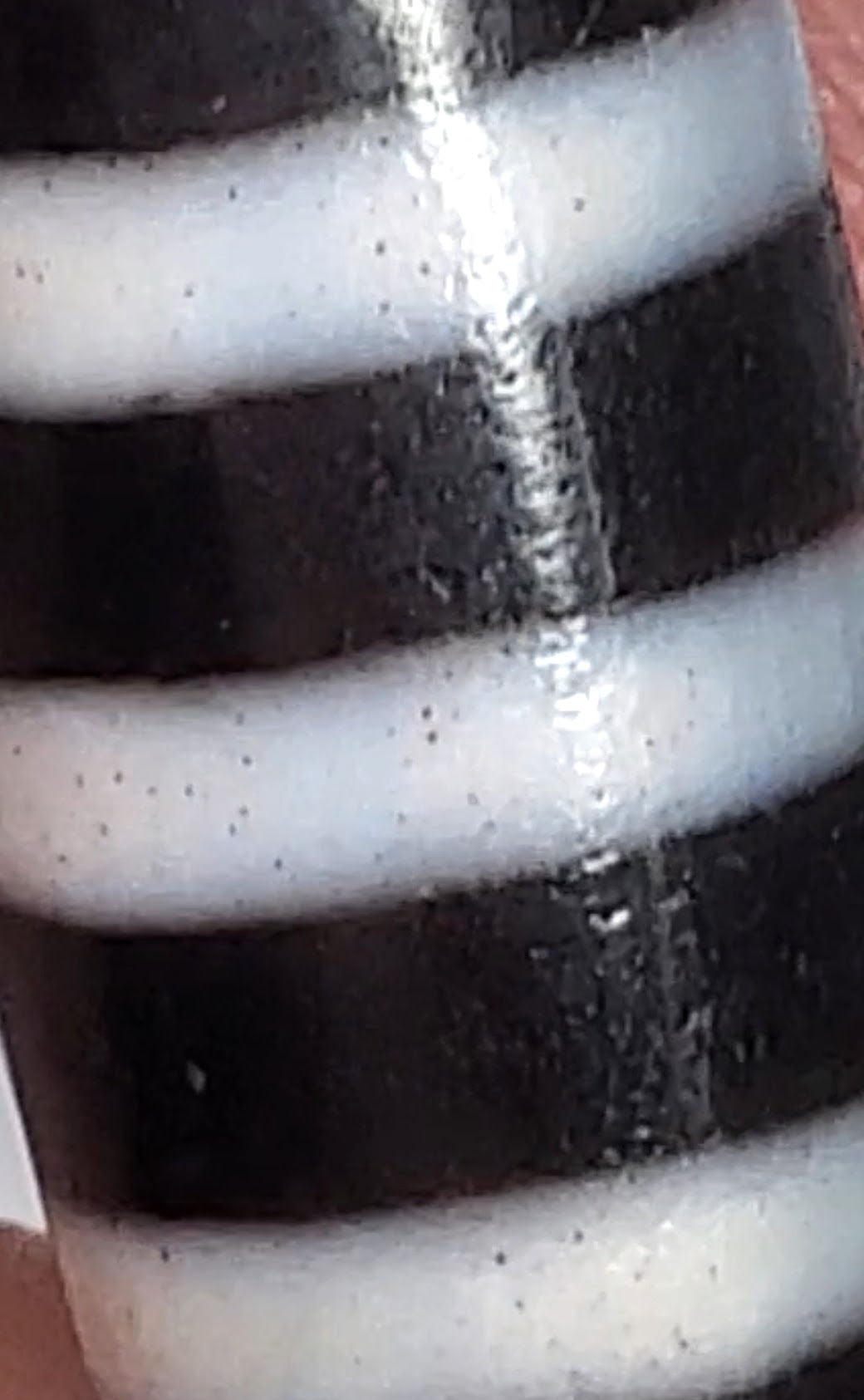 Antique nine-stripe chung dzi bead, pitch-black agate, white bands, visible bloodspots, aged patina, 44.7mm