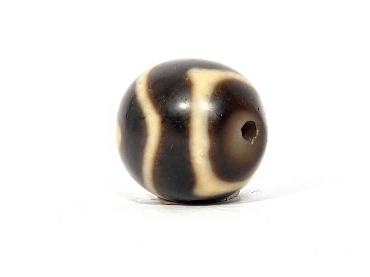 At-111325-WTT antique round wave tiger tooth dzi, opposite drill end, motif wrapping to edge, unretouched