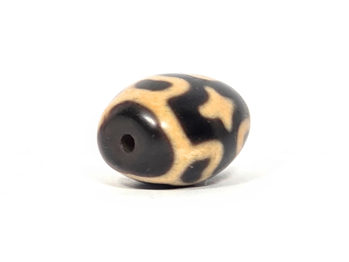 At-121025-6ELC2 antique round six eye lotus cross dzi, drill end view, dark end cap, hole centred, unretouched