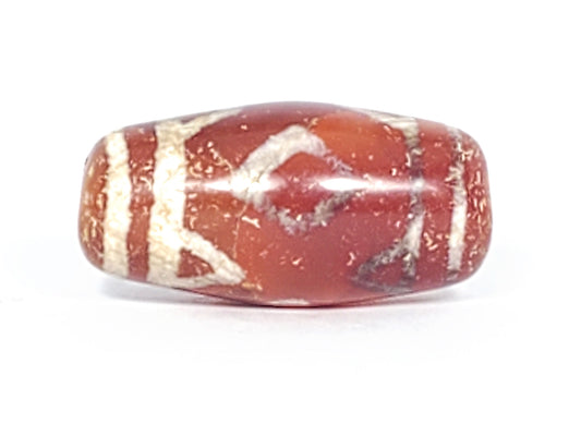 Antique Three Diamond Eye Tiger Tooth dzi At-053126-3DETT, front face, two dark brown diamond eye forms on warm terracotta-red agate, 27.5mm × 13.0mm disc-like barrel, unretouched