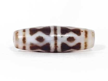 At-082524-DS antique diamond spear agate dzi 40.5x13.1mm angled view gradual taper end cream-white drill hole unretouched