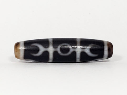 Antique Tibetan dzi bead, black agate, Guru Rinpoche scepter motif, white etched pattern, bloodspots, aged patina, elongated barrel shape