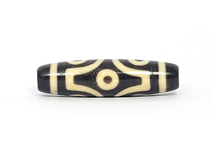 Face C of antique six eye dzi At-042925-6E2, two C-ring eyes with generous scroll arc on pitch-black agate, bold cream motif, paired-eye composition, unretouched