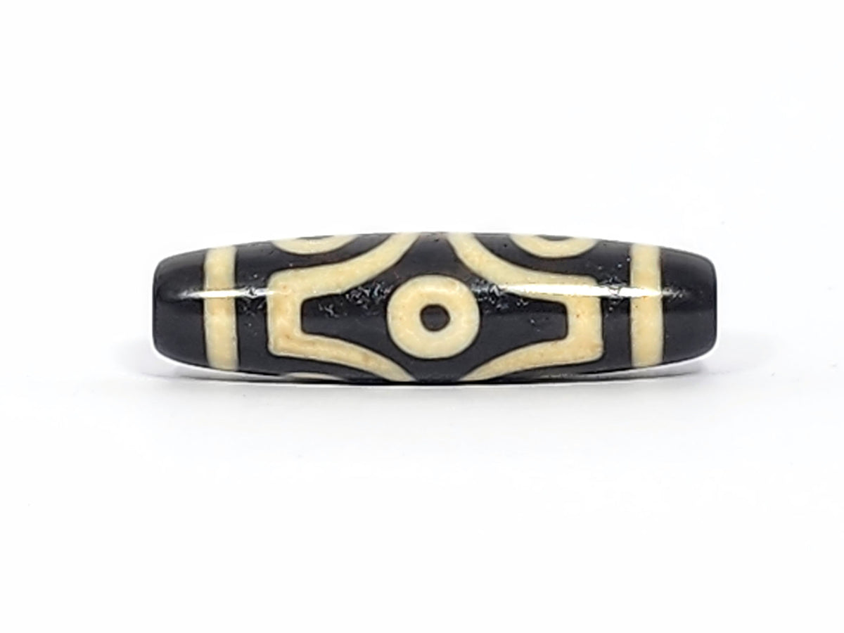 Antique six eye dzi At-042925-6E2, Face A, two open C-ring eyes with bold scroll connector on pitch-black agate, bright cream motif, 41.4mm × 11.4mm, unretouched