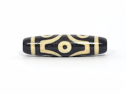Antique six eye dzi At-042925-6E2, Face A, two open C-ring eyes with bold scroll connector on pitch-black agate, bright cream motif, 41.4mm × 11.4mm, unretouched