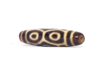 Opposite end of antique Tibetan Naga Dragon Eye dzi bead showing drill hole and paired eye motif, At-092524-6EN