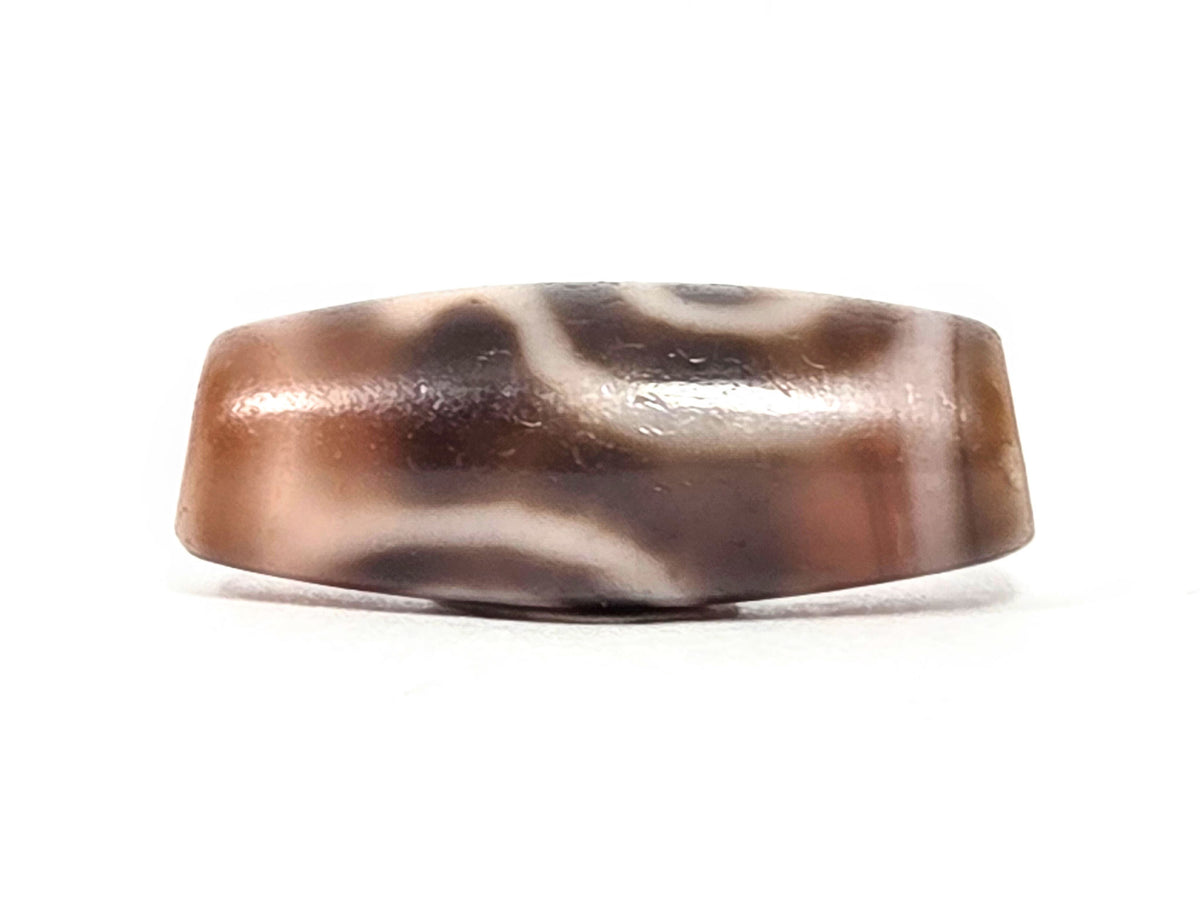 At-061826-2ETV top face, faceted hexagonal profile visible, warm reddish-brown translucent chalcedony ground, unretouched