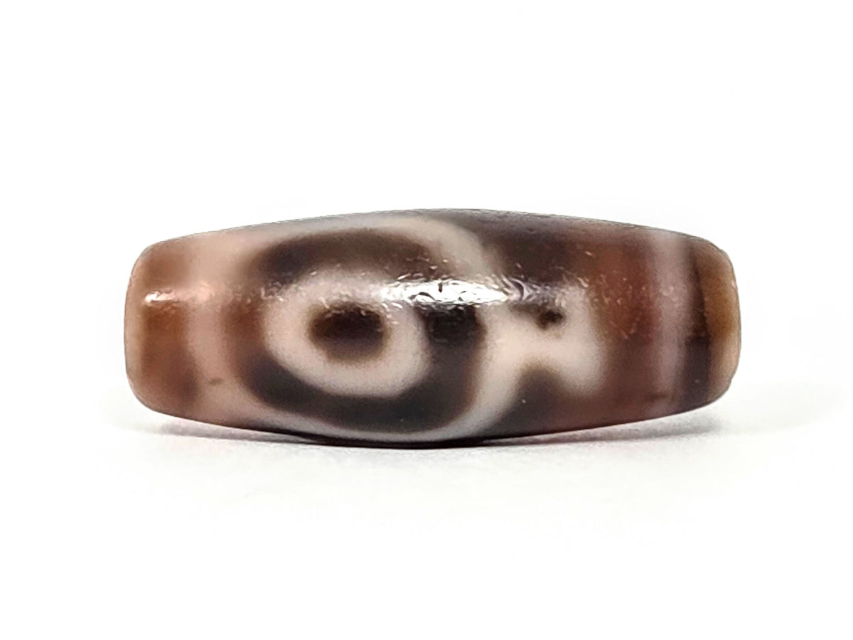 At-061826-2ETV Face B, closed oval eye ring on warm chocolate-brown chalcedony, soft-edged cream motif lines, unretouched