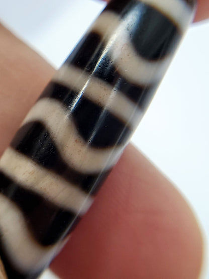 Reverse side of antique Tibetan Wave Stripe dzi bead, bold black and cream agate banding, At-052526-WS
