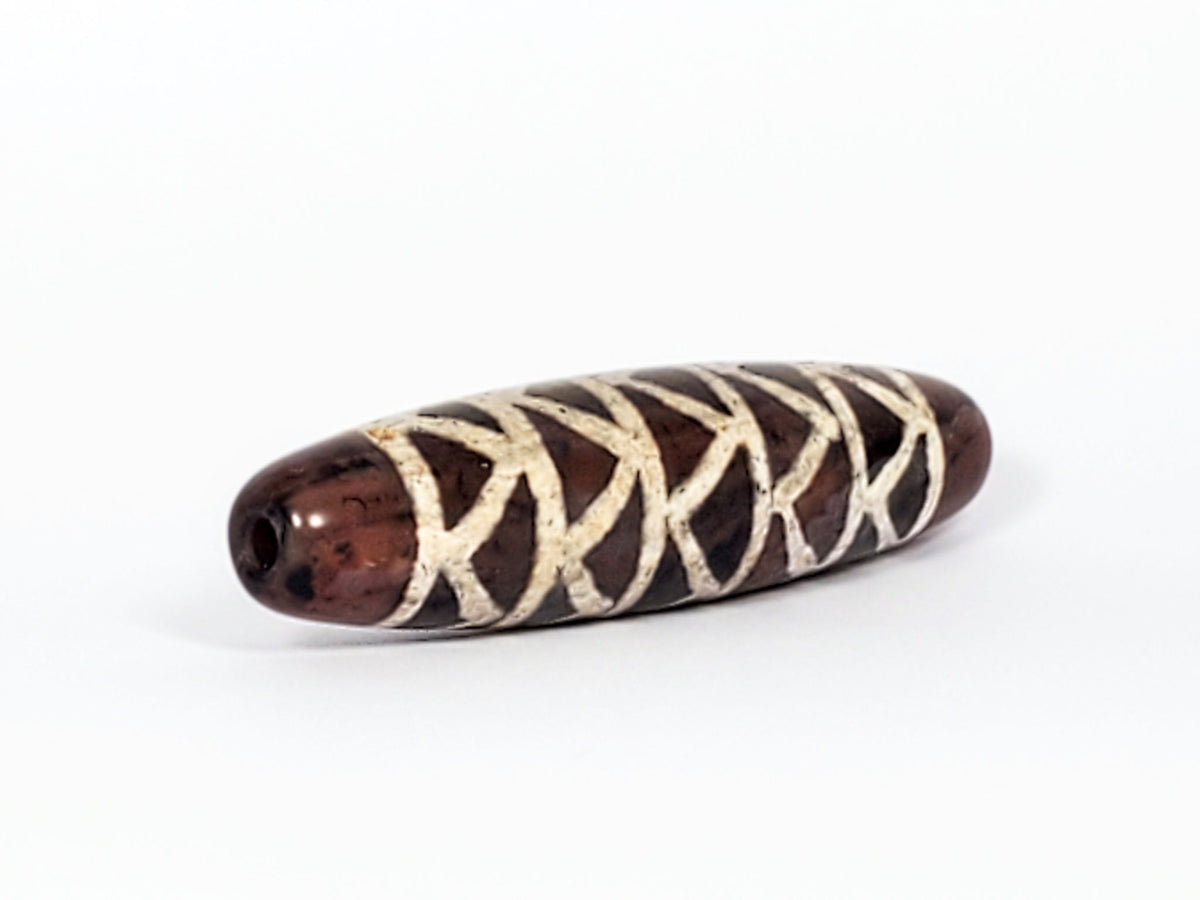 At-040524-TTStr antique carnelian dzi, right end cap, warm reddish-brown cap, drill hole, motif wrap detail, unretouched