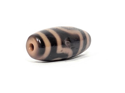 At-033126-2E5, sandy-cream end cap with drilled hole, angled view, dark-brown body, unretouched photo