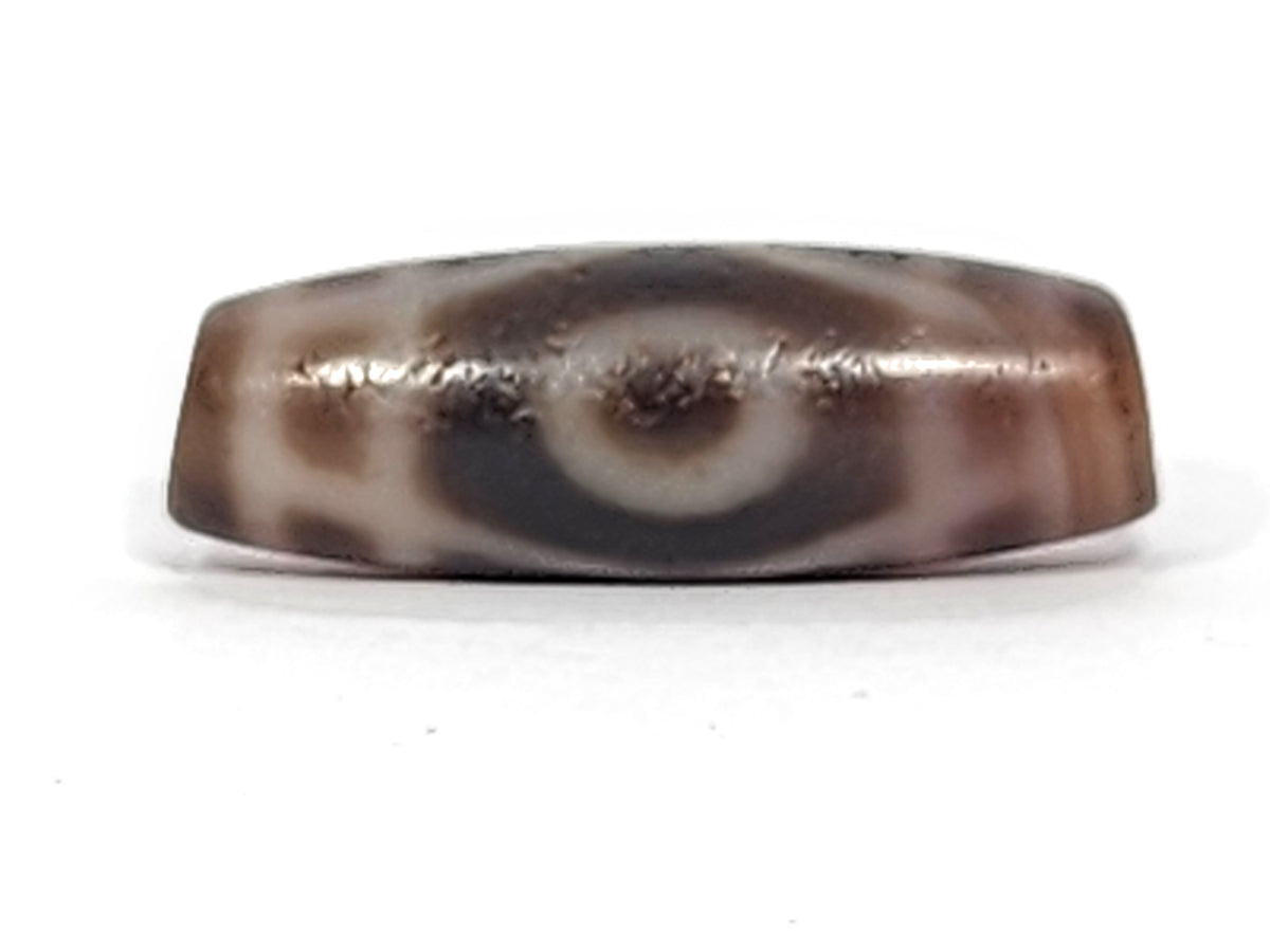 Antique two-eye dzi bead agate brown white swirl pattern bloodspots aged patina surface elongated barrel shape