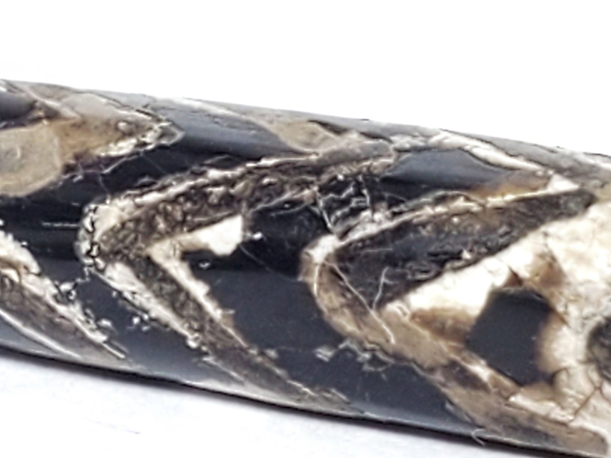 Extreme macro of calcification surface on ancient Four-Row Tiger Tooth Dzi bead — cracked mineral layers over tiger tooth chevron etching, 800–1,000 years of geological accretion