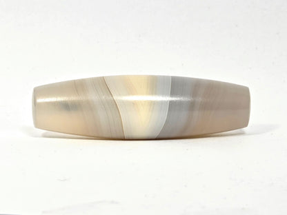 N-N-062126-1E2 dzi bead, side profile showing parallel diagonal banding, unretouched