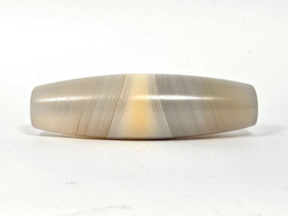 N-N-062126-1E2 dzi bead, angled side view, full band sweep visible, unretouched