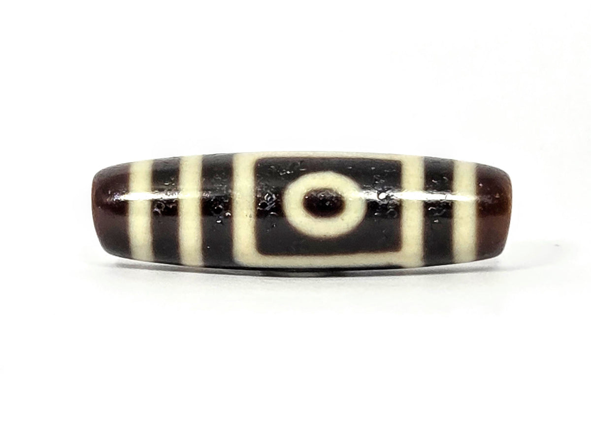 Two-eye dzi bead, dark brown and black agate with cream stripes, drilled horizontally, polished surface