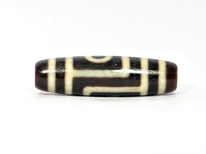 Two-eye dzi bead, dark brown and cream agate with striped pattern, polished surface, 39.9×11.6mm