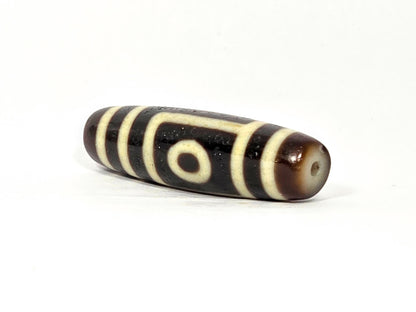 Two eye dzi bead, dark brown and black agate with cream stripes, 39.9×11.6mm, polished surface with drill hole