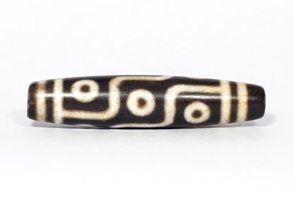 N-062226-9E2, face C, nine eye dzi, very deep dark warm brown, cream motif with honey-tan warmth, unretouched