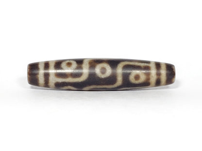 N-062226-9E3, nine eye agate dzi, 58.6×12.9mm, medium-dark warm brown, sandy-cream motif, face A, unretouched