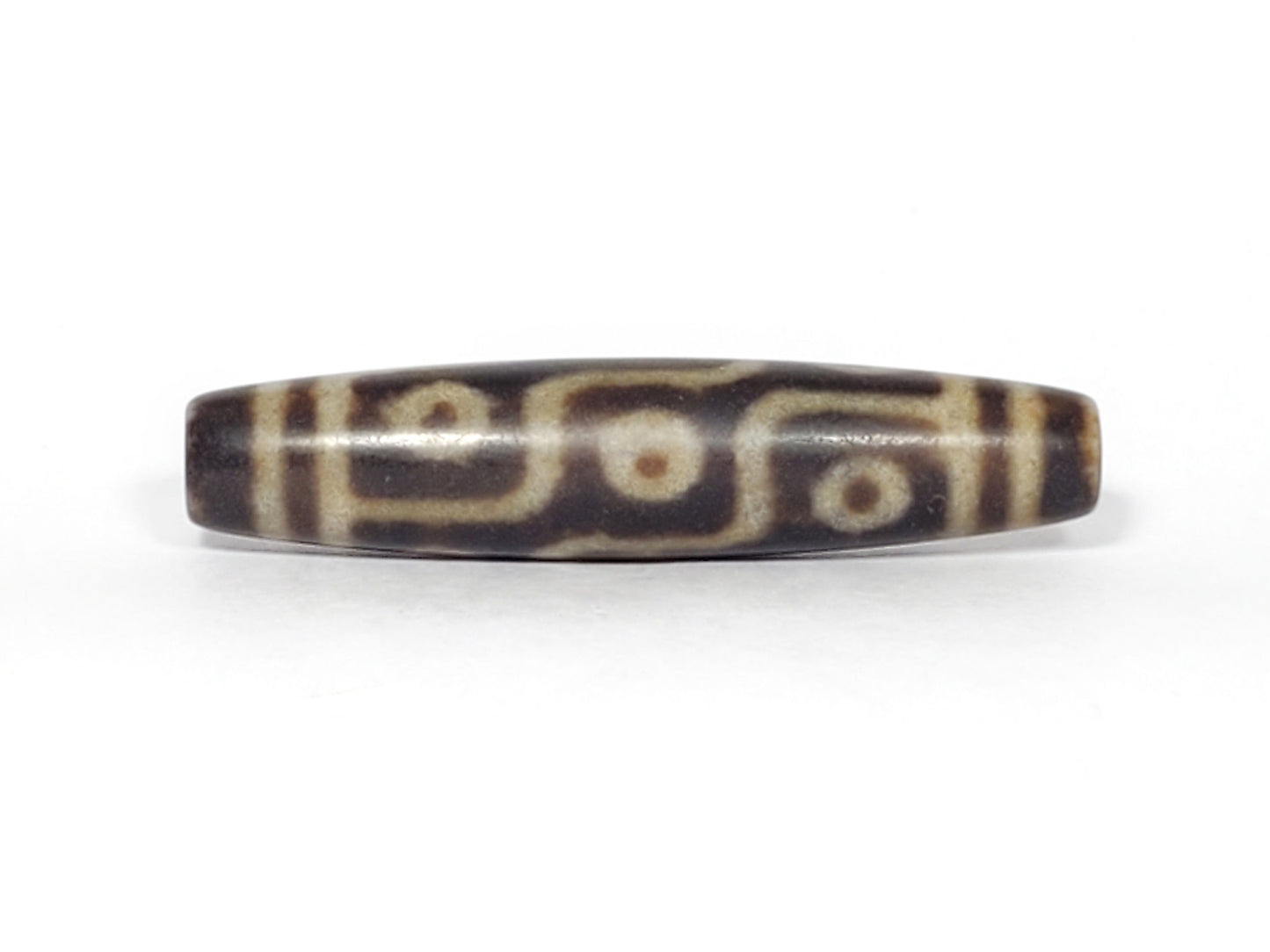 N-062226-9E3, face B, nine eye motif, medium-dark warm brown ground with banding variation, matte surface, unretouched