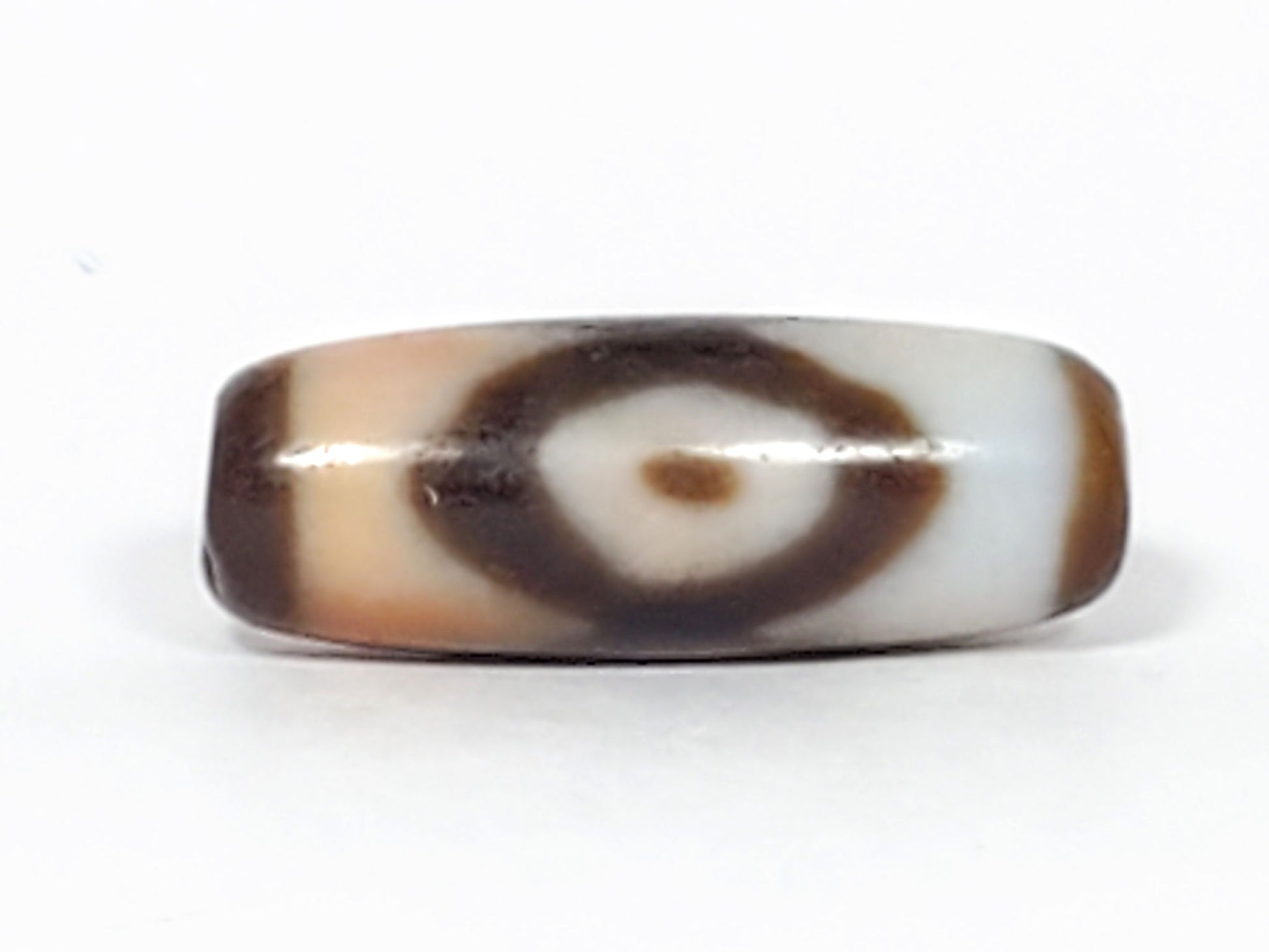 N-062226-3E, face B, lens-shaped eye, bright white ground zone, dark brown ring, honey-tan interior, unretouched