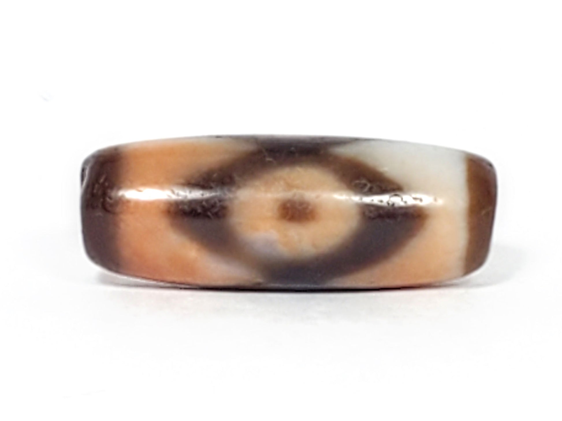 N-062226-3E, face C, three eye dzi, peach-orange dominant ground, dark brown eye form, compact barrel, unretouched