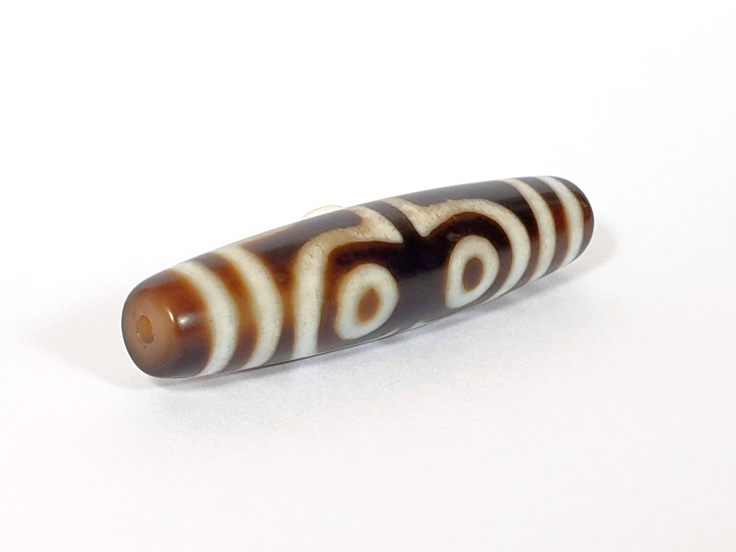 N-062426-4E new four eye dzi 58.5x13.9mm reverse angled view opposite taper end warm brown agate unretouched