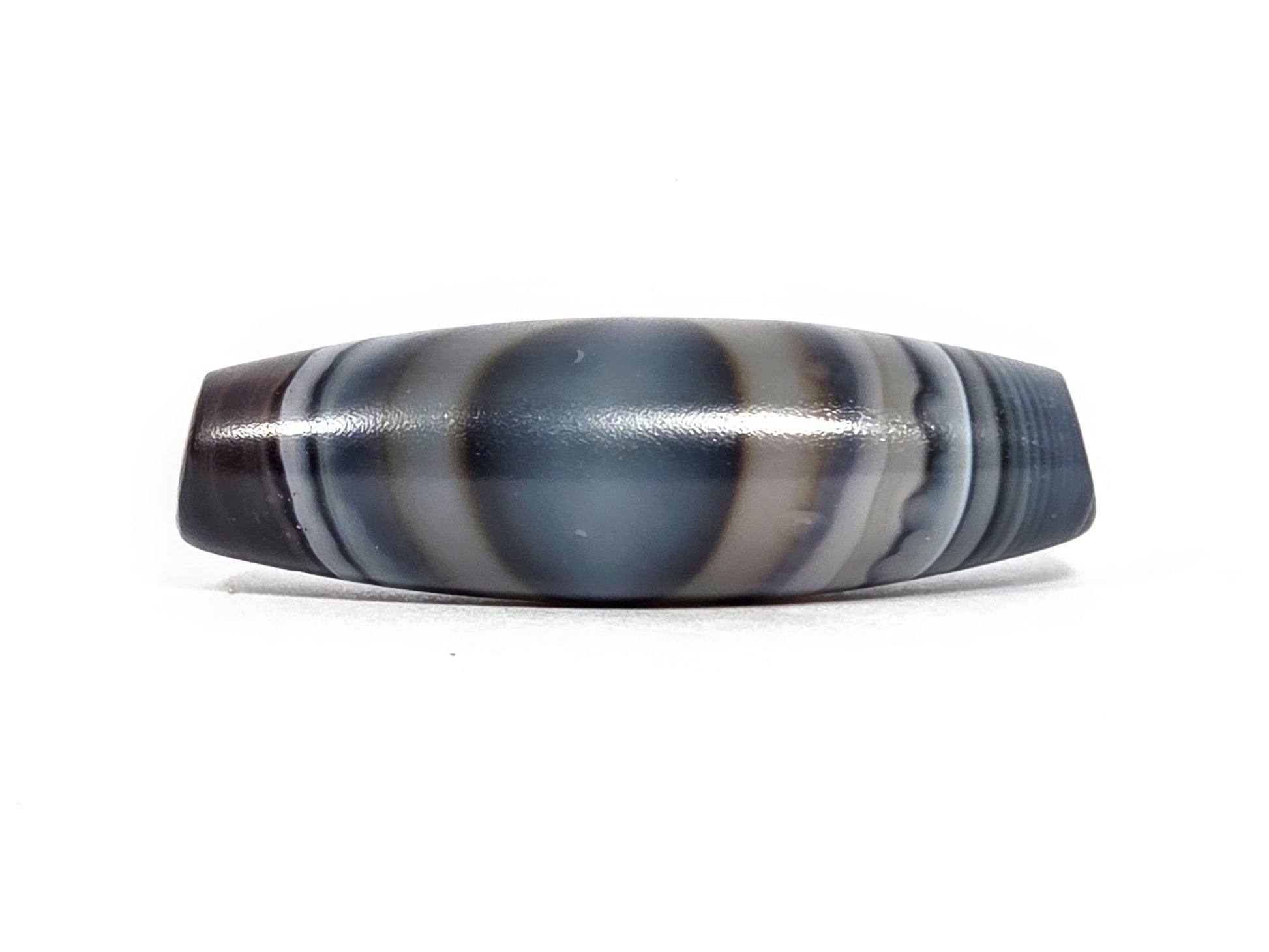 N-N-080926-1E6 natural one eye dzi bead 50.5×15.8mm, Face A showing broad blue-grey oval eye dome with cream stripe borders, unretouched