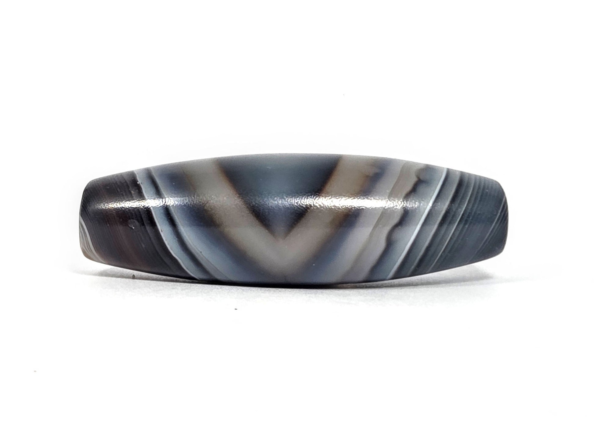 N-N-080926-1E6 natural one eye dzi bead 50.5×15.8mm, Face B showing strong chevron V-banding in blue-grey agate, eye reading dissolved, unretouched