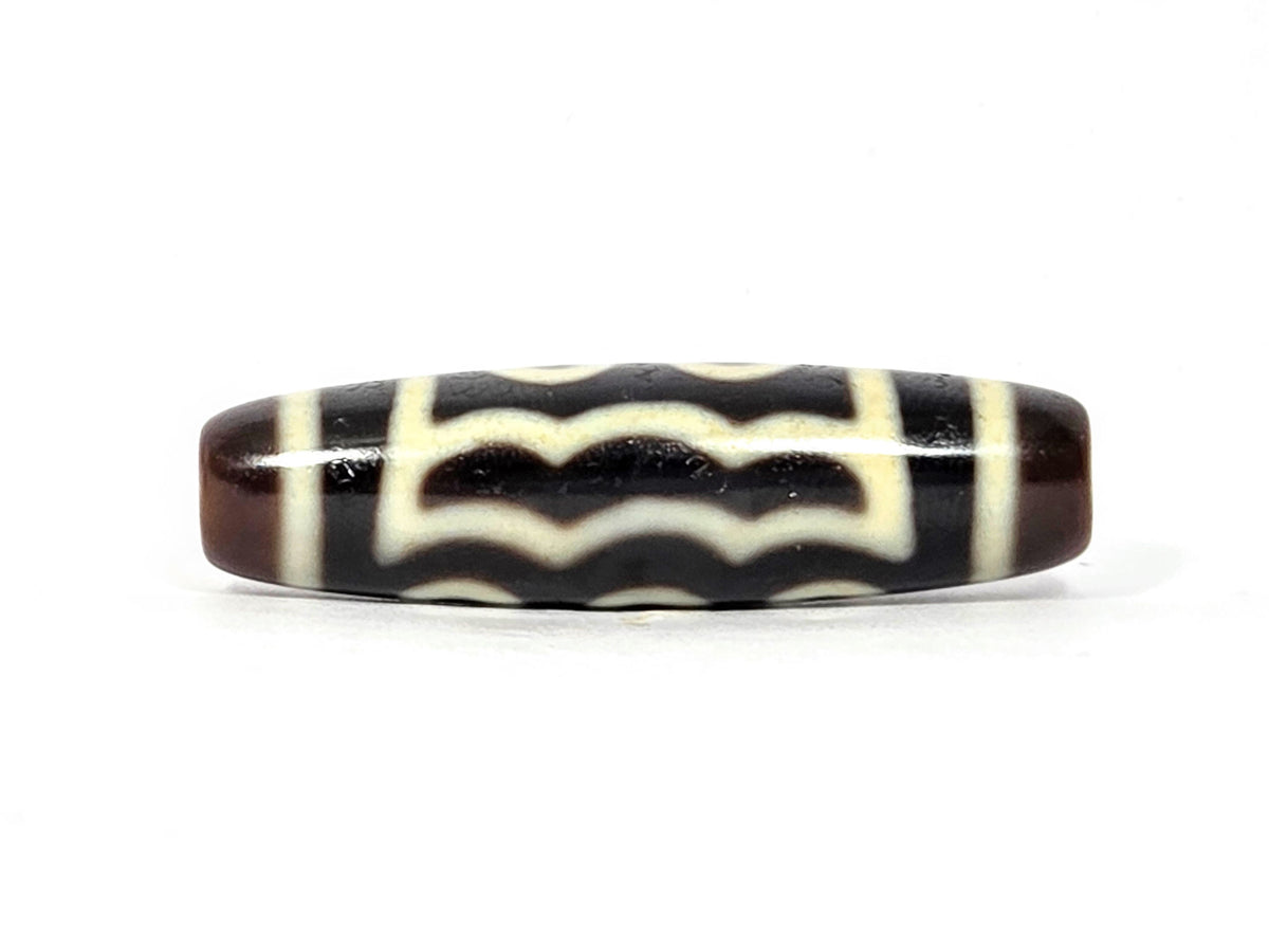 Five-eye dzi bead, dark brown agate, cream wave motif pattern, elongated oval shape, smooth polished surface, 41mm