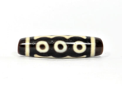 Five-eye dzi bead, dark brown agate, cream eye motifs, vertical stripe pattern, smooth polished surface, 40.5x11mm barrel shape