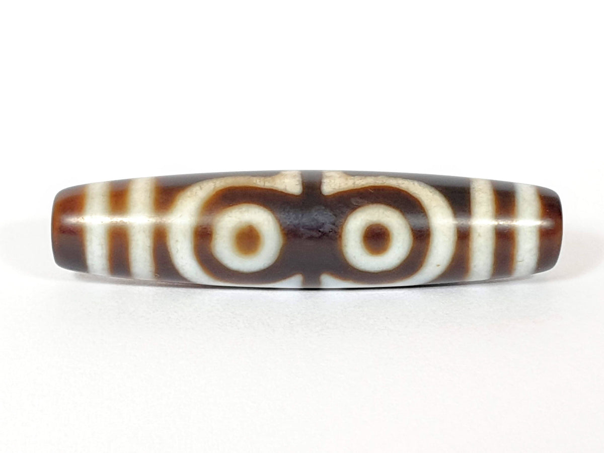N-062426-4E new four eye dzi 58.5x13.9mm Face B two closed-ring eyes connected at centre warm brown agate unretouched