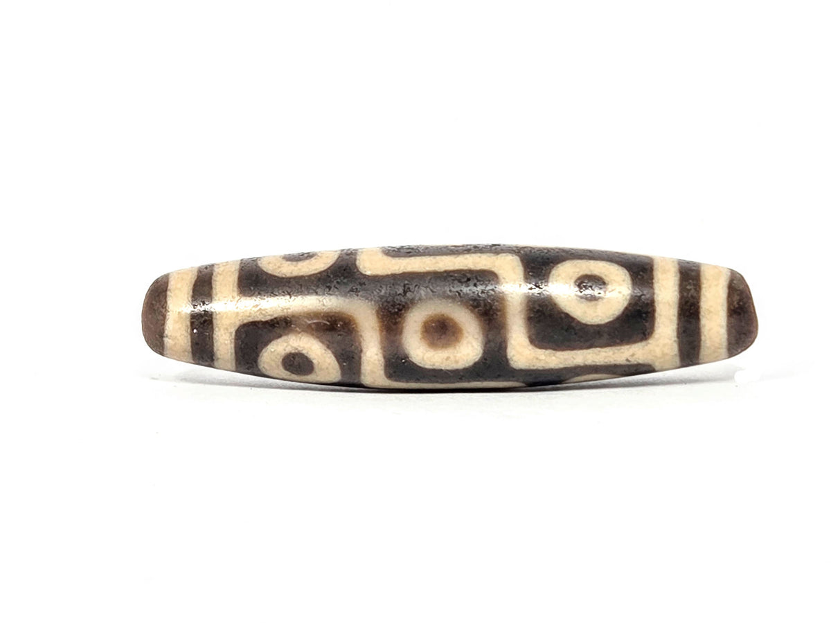 Decorative agate dzi bead with eye motif, cream and brown striped patterning, polished surface, drilled ends