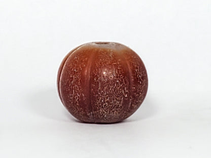 Ac-061126-PKP Bead B angled drill hole end, golden-brown zone with natural banding, weathered bore, unretouched