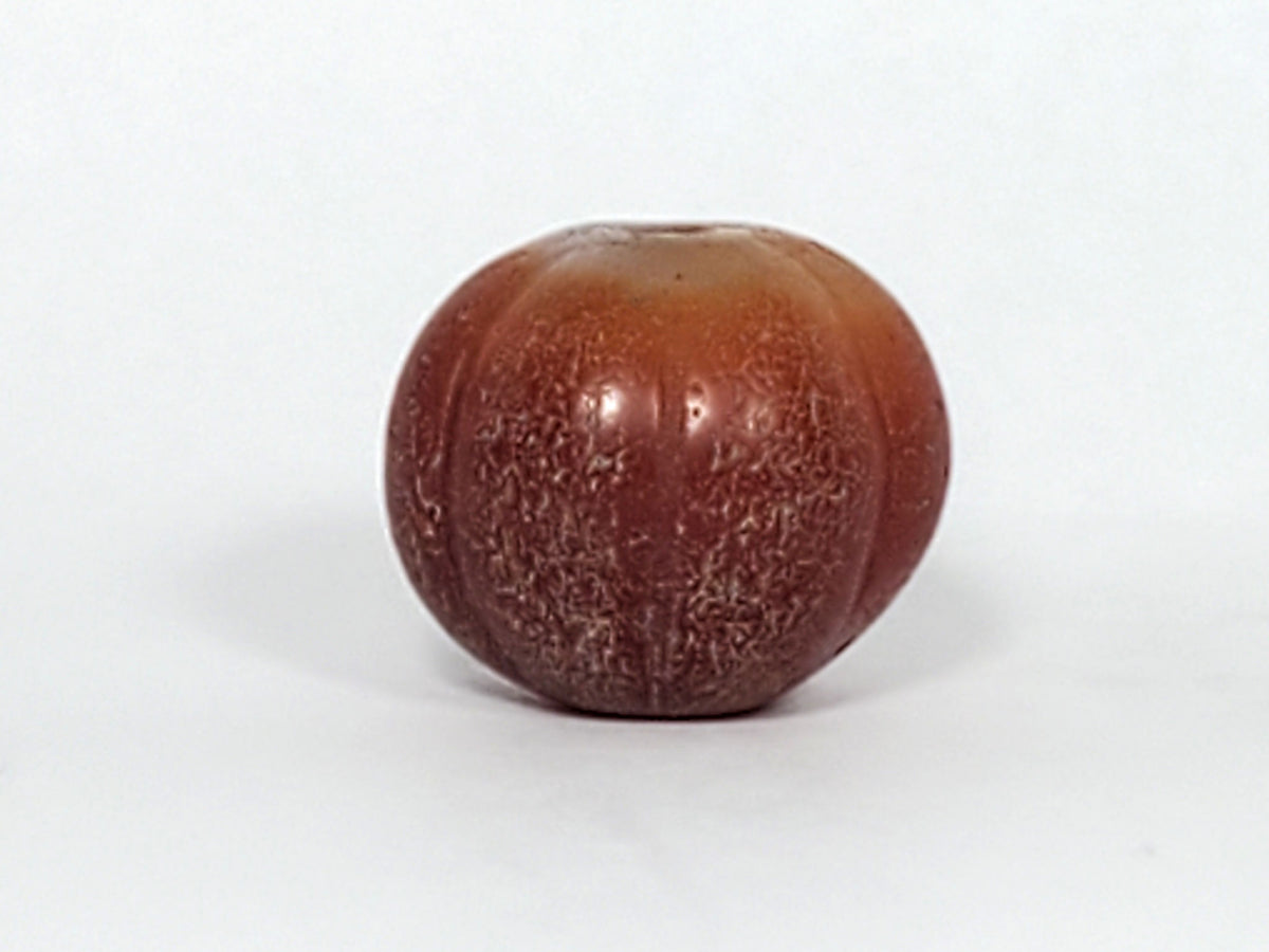 Ac-061126-PKP Bead B drill hole face, lobed pumpkin outline from pole, natural banding fanning from bore, unretouched