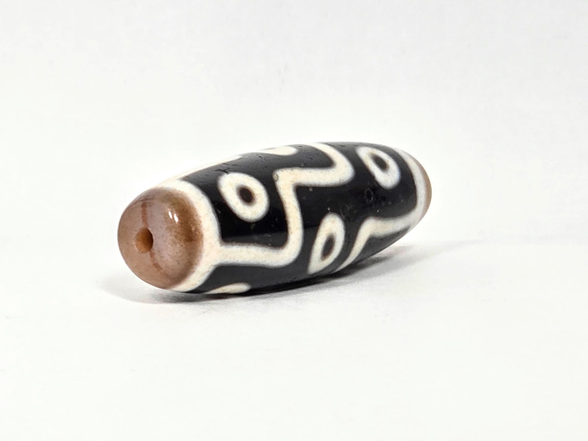 At-061926-9E6BS angled tip B, warm sandy-tan end cap, small drill hole, compact form visible, unretouched