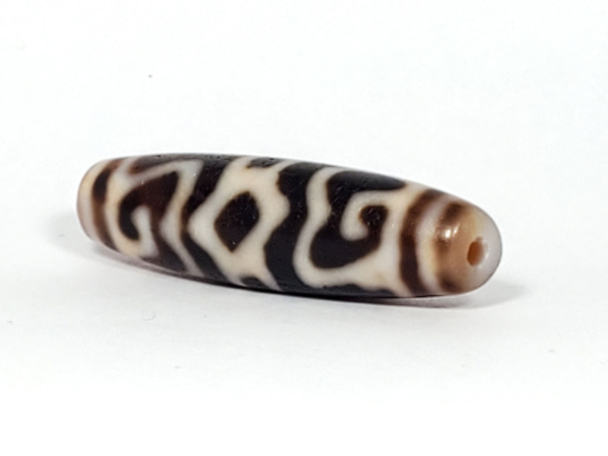 Ac-061926-GRDC angled tip A, elongated fusiform form, honey-brown cap, small drill hole, unretouched