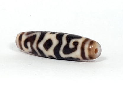 Ac-061926-GRDC angled tip A, elongated fusiform form, honey-brown cap, small drill hole, unretouched
