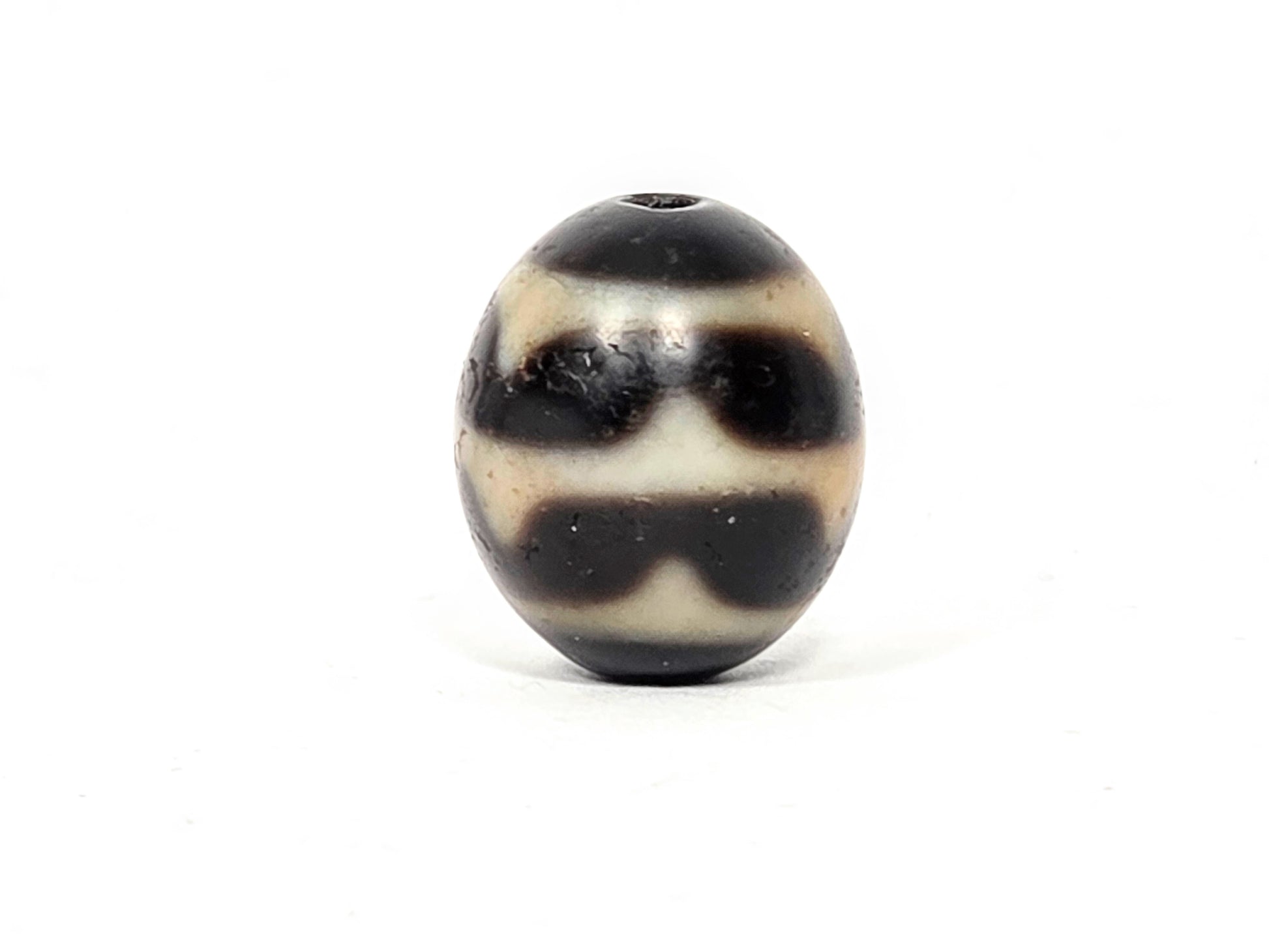 Close-up of Double Wave motif etching on vintage round Taiwan Dzi bead — authentic 1980s natural agate — unretouched photo — Ancient Dzi Shop
