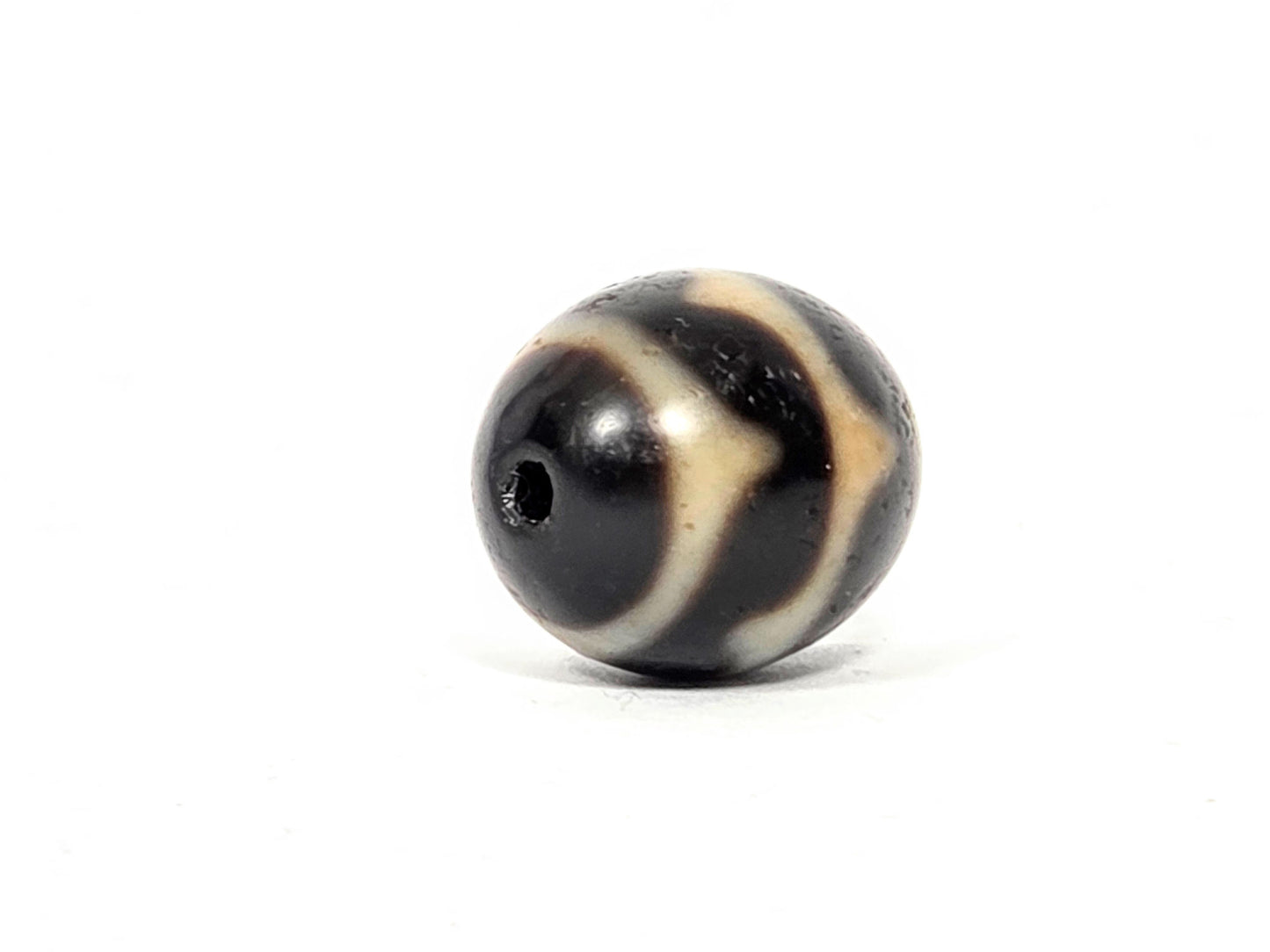 V-062926-DW drill-end angle 2, very dark brown dominant, cream chevron, standard drilling, vintage agate, unretouched