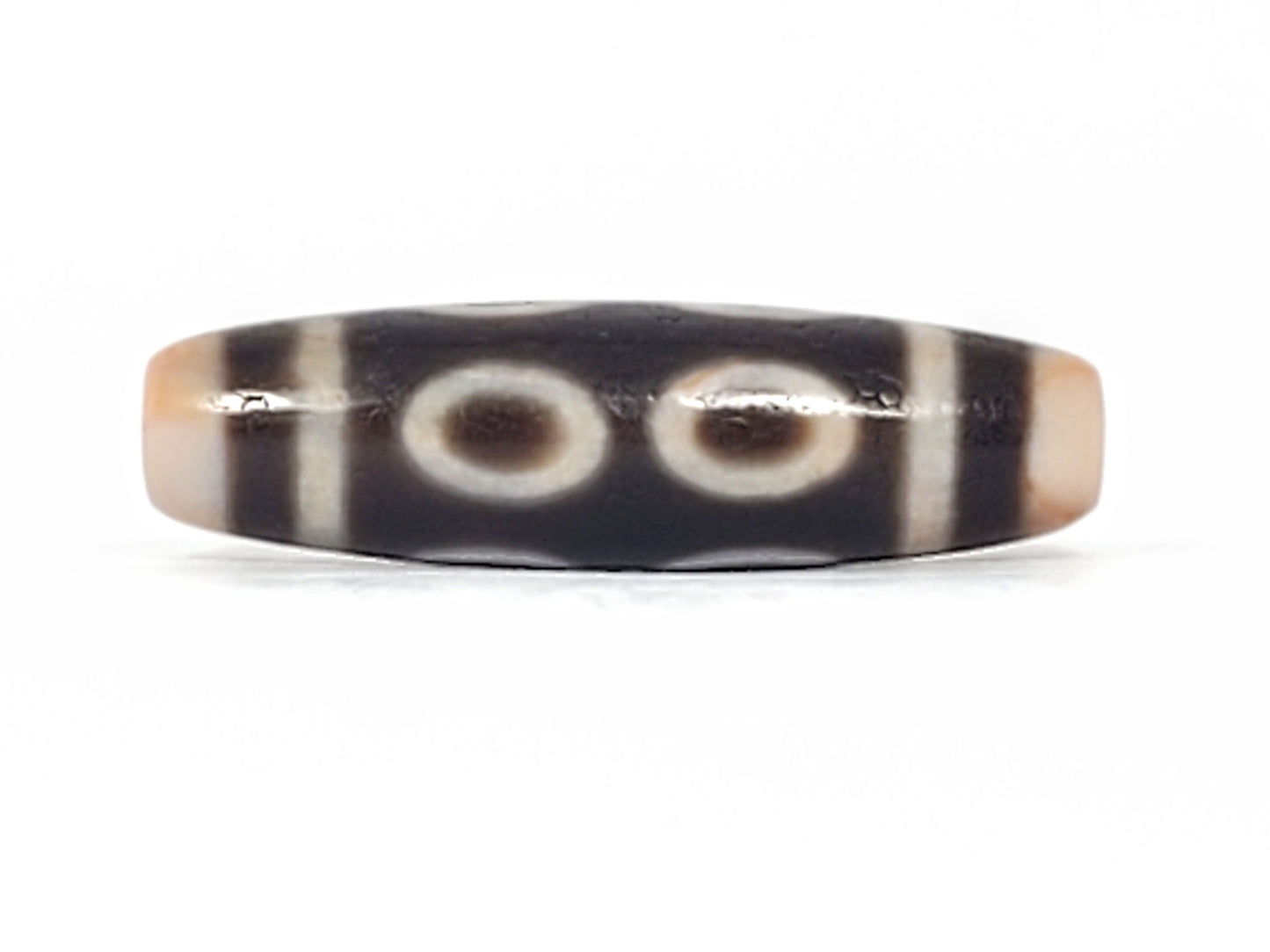 V-092924-8EBS Eight Eye dzi bead, rotated face showing four eyes, minor equatorial surface marks visible, unretouched